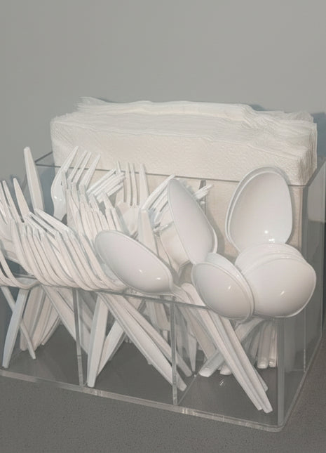 Clear plastic container with cutlery on a gray countertop