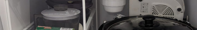 Cabinet with a slow cooker and storage shelves inside