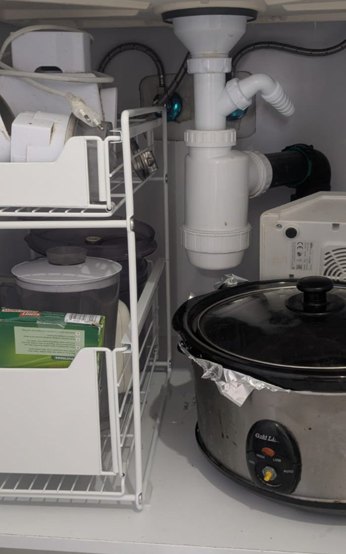 Cabinet with a slow cooker and storage shelves inside