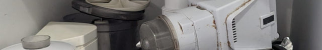 Under-sink kitchen setup with a water filter and plumbing components.