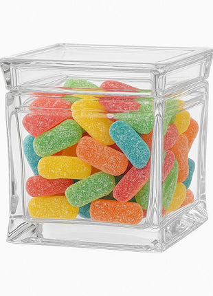 Clear glass jar filled with colorful gummy candies on a white background