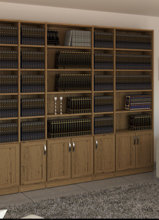 Wide oak open wall bookcase with five columns and lower cabinet doors in a living room setting