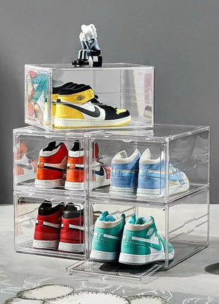 Clear acrylic shoe display boxes with variously colored sneakers on a gray floor.